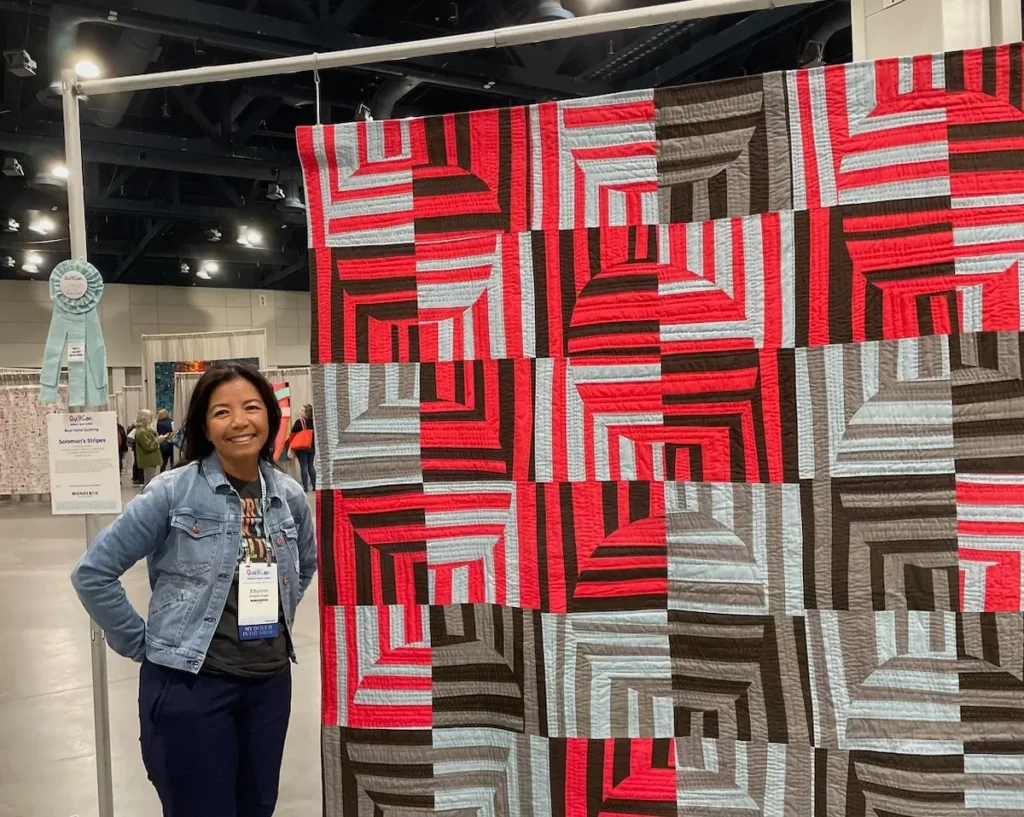 Ethylene Ziegler and her quilt at QuiltCon